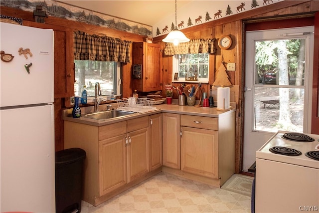 kitchen with sink, white appliances, light tile patterned floors, and plenty of natural light