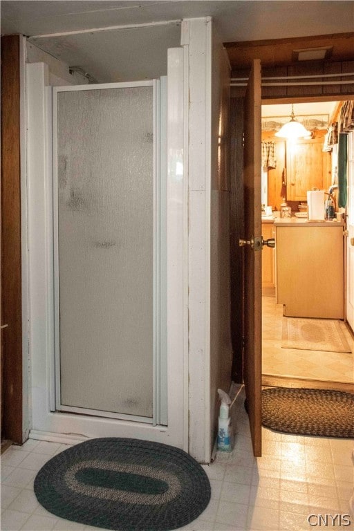 bathroom featuring a shower with shower door and tile patterned floors