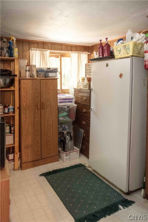 kitchen with white refrigerator and light tile patterned floors