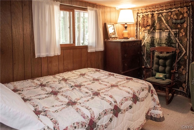 carpeted bedroom featuring wood walls