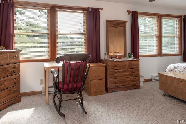 carpeted office featuring a baseboard heating unit