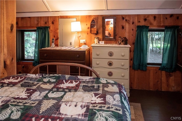 bedroom featuring wood walls and dark wood-type flooring