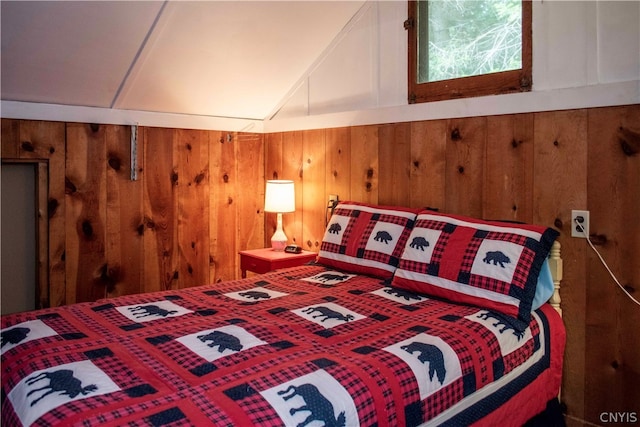 bedroom featuring wooden walls