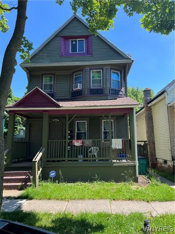 view of front facade with cooling unit and covered porch