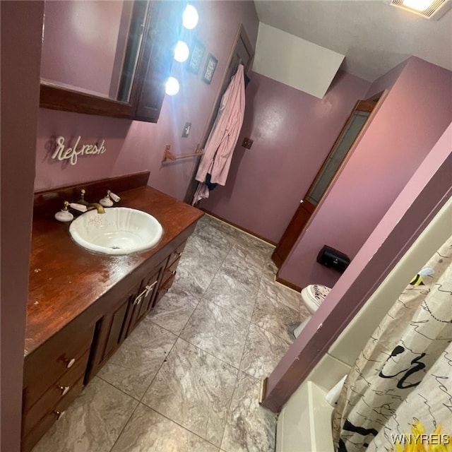 bathroom with vanity, tile patterned flooring, and toilet