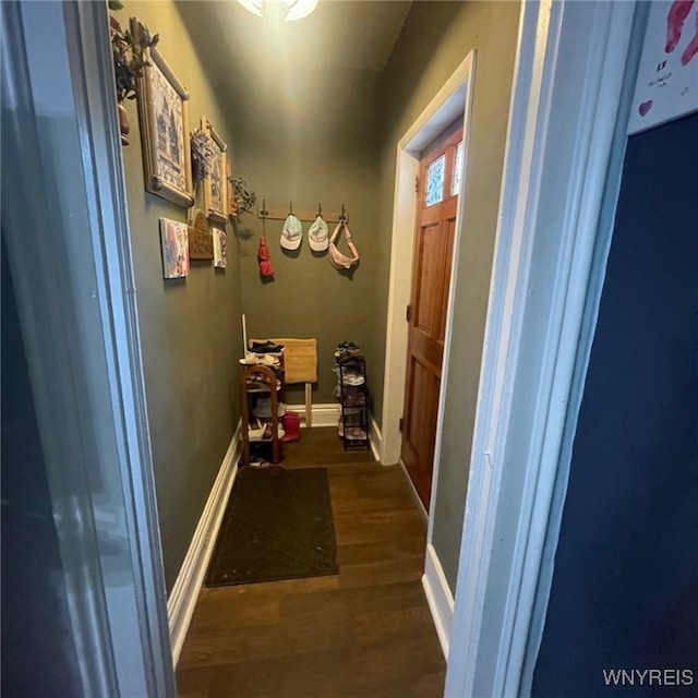 corridor with dark hardwood / wood-style flooring