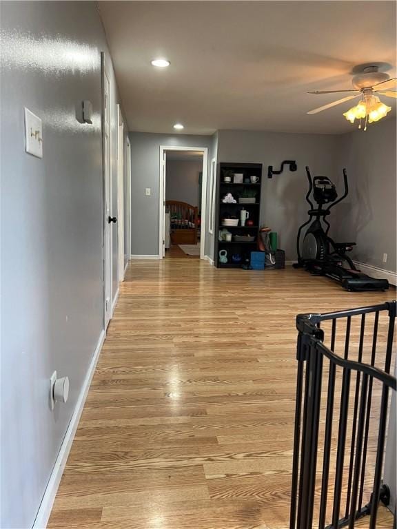 hallway with recessed lighting, baseboards, and light wood-style floors