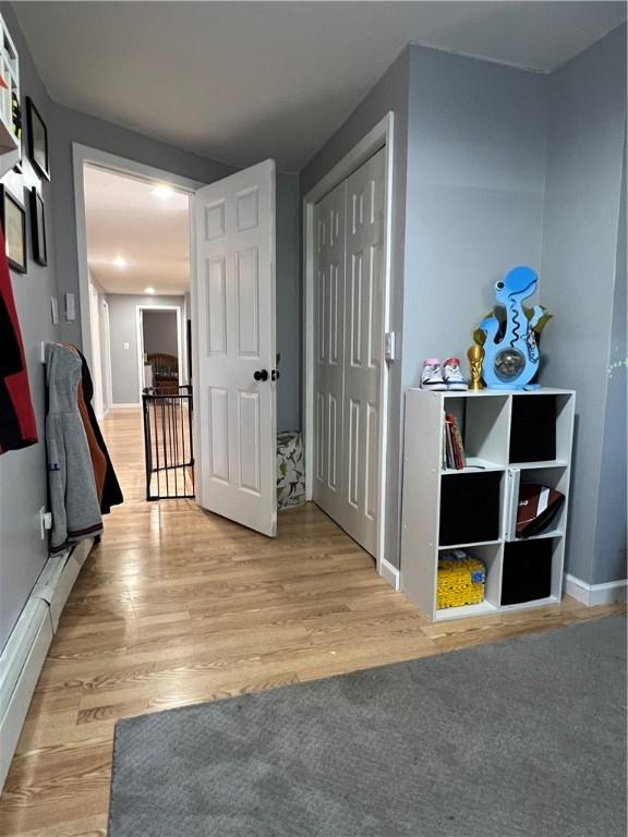 hallway with baseboards and light wood finished floors