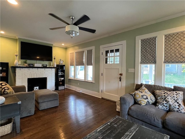 living area featuring ornamental molding, a healthy amount of sunlight, and wood finished floors