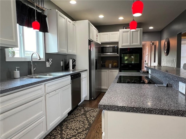 kitchen with white cabinetry, black appliances, recessed lighting, and a sink