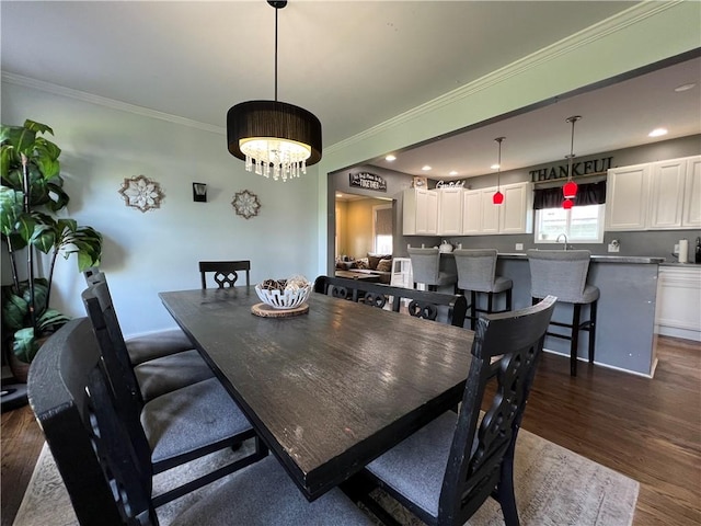 dining room featuring dark wood-style floors, a notable chandelier, recessed lighting, and ornamental molding