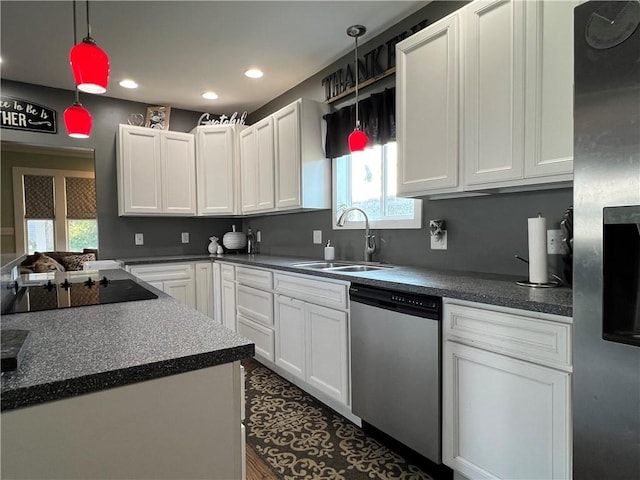 kitchen with recessed lighting, a sink, stainless steel appliances, white cabinets, and dark countertops