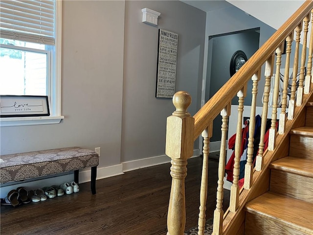 staircase with wood finished floors and baseboards