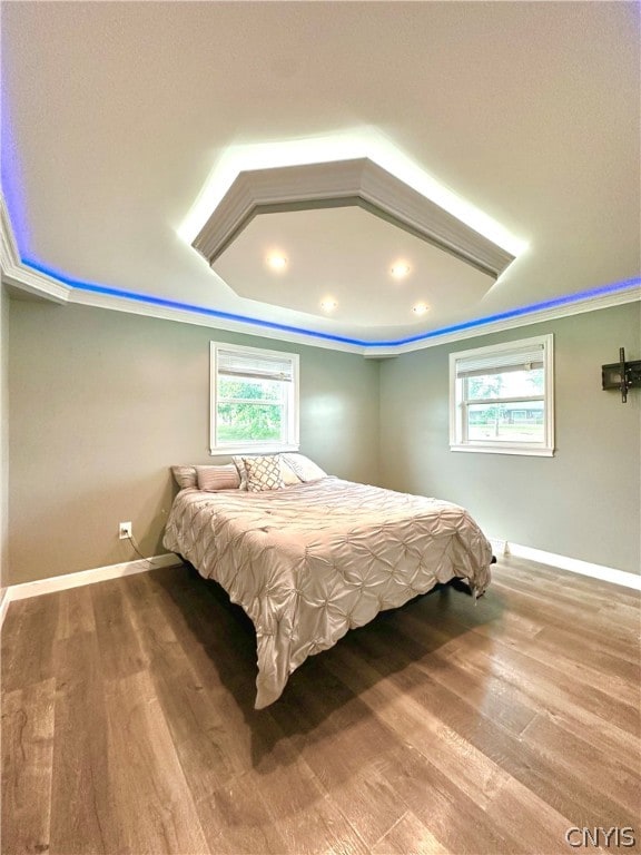 bedroom featuring ornamental molding and hardwood / wood-style flooring