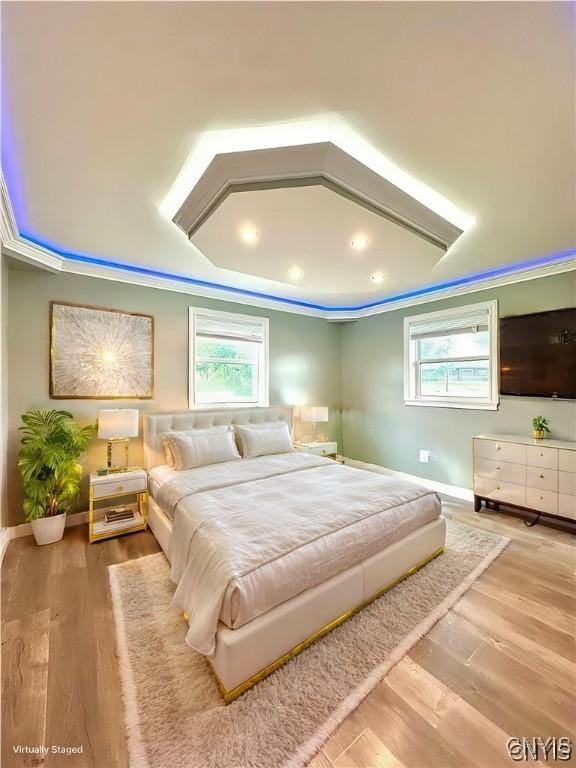 bedroom with hardwood / wood-style flooring and ornamental molding