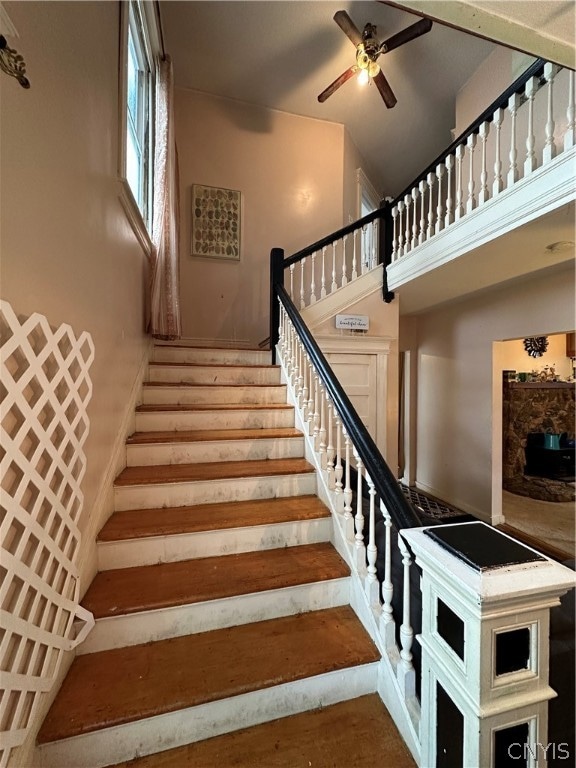 stairway with a high ceiling and ceiling fan