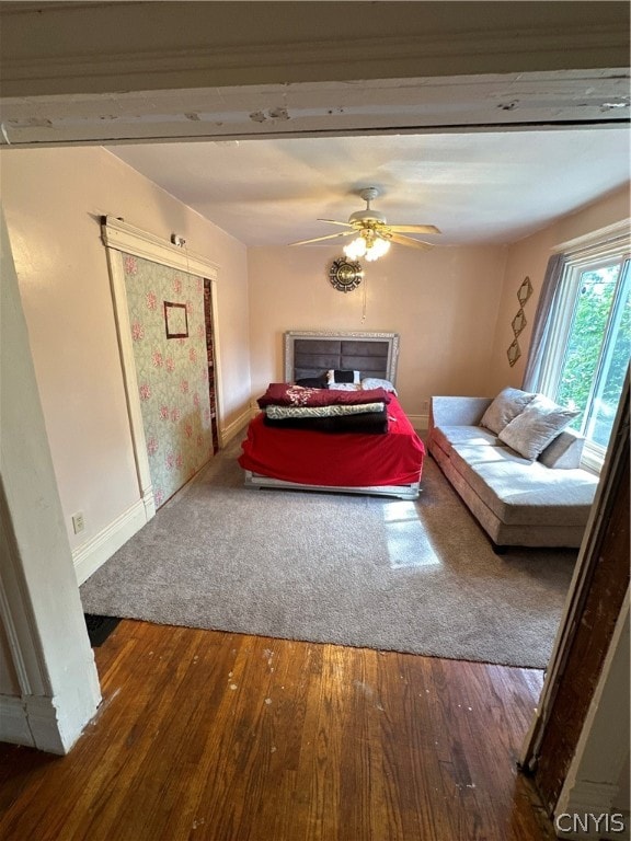 unfurnished bedroom with ceiling fan and hardwood / wood-style floors