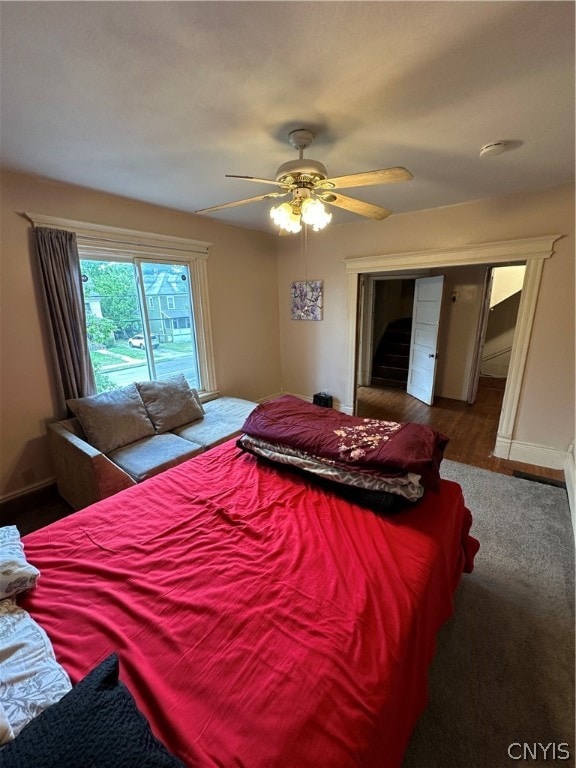 bedroom with ceiling fan and hardwood / wood-style floors