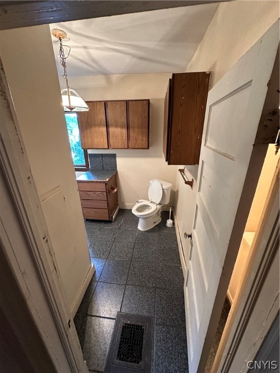 bathroom featuring toilet and tile patterned floors