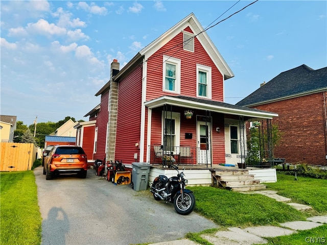 view of front facade with covered porch and a front yard