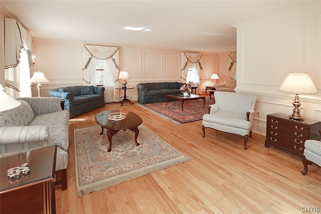 living room with a healthy amount of sunlight and light hardwood / wood-style flooring