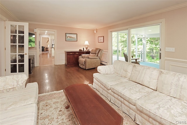 living room featuring a baseboard radiator, hardwood / wood-style flooring, and ornamental molding