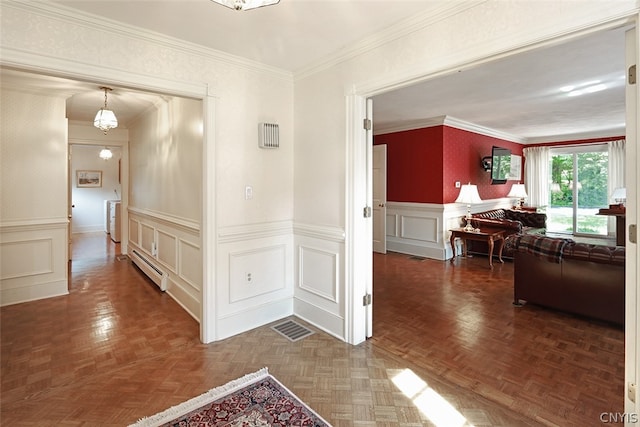 hall with ornamental molding, a baseboard heating unit, and parquet flooring