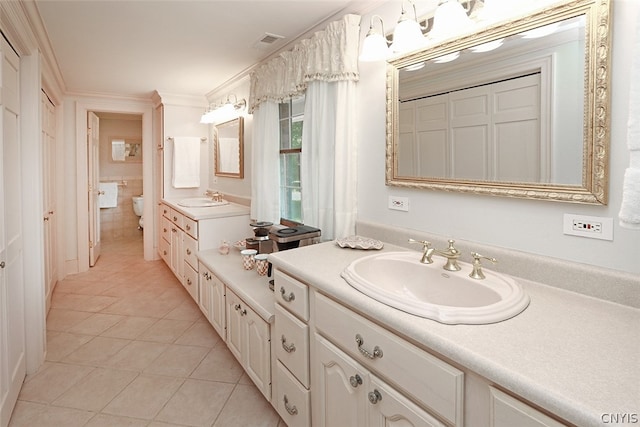 bathroom with tile patterned floors, crown molding, and double sink vanity