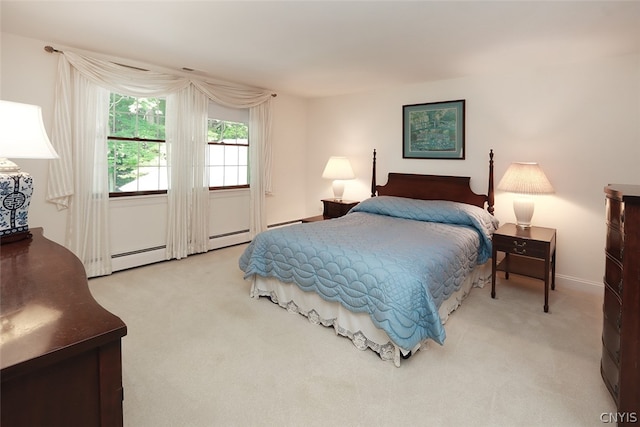 carpeted bedroom with a baseboard heating unit