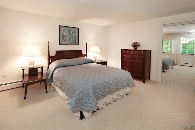 bedroom featuring light carpet and baseboard heating