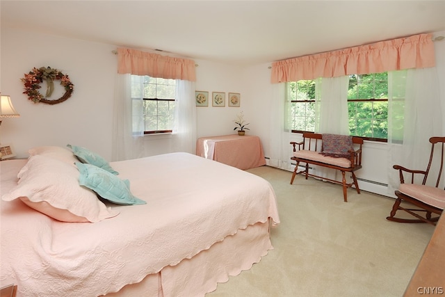 bedroom with multiple windows, baseboard heating, and carpet flooring