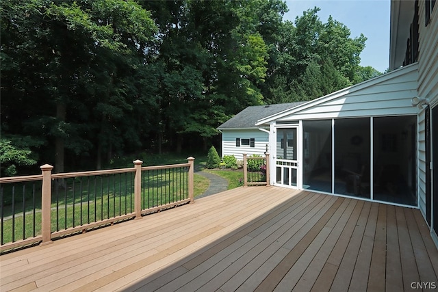 deck with a yard and a sunroom