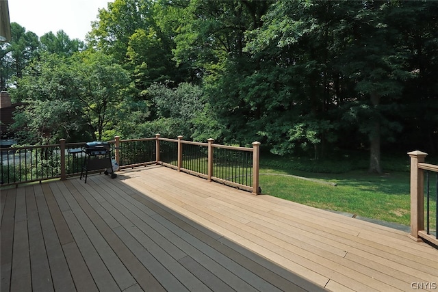 wooden terrace with a lawn