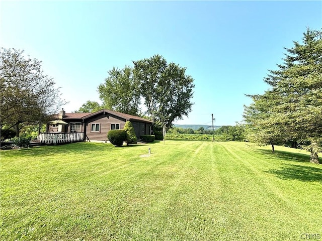 view of yard with a wooden deck