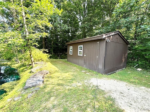 view of outbuilding featuring a yard