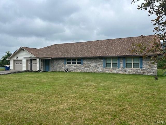 ranch-style home featuring a garage and a front yard