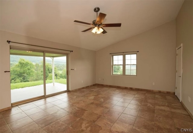 spare room featuring lofted ceiling, light tile patterned floors, and ceiling fan