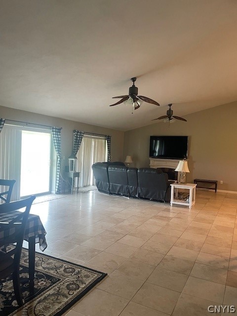 tiled living room with ceiling fan