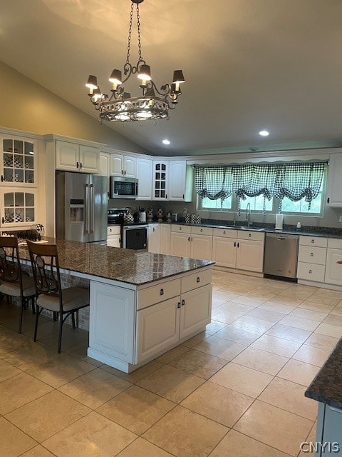 kitchen featuring an inviting chandelier, a center island, white cabinetry, and stainless steel appliances