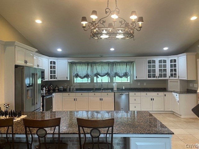 kitchen with white cabinetry, a notable chandelier, light tile patterned floors, appliances with stainless steel finishes, and sink