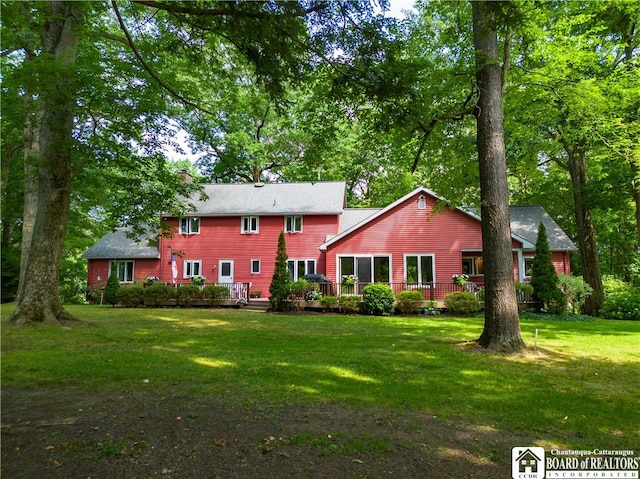 back of property featuring a lawn