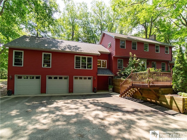 view of front of property featuring a deck and a garage