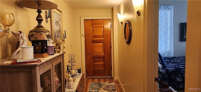 corridor with hardwood / wood-style flooring