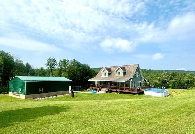 view of property's community with a pool side deck and a yard