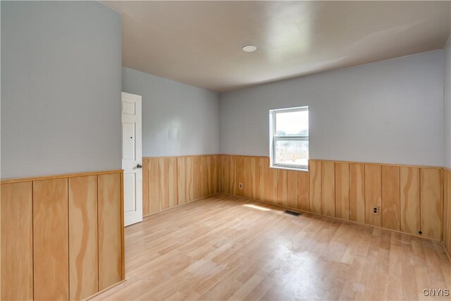 unfurnished room featuring light hardwood / wood-style flooring