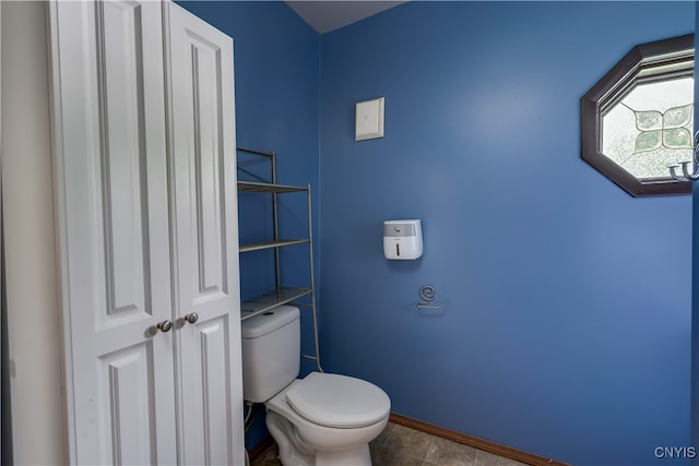 bathroom with tile patterned flooring and toilet