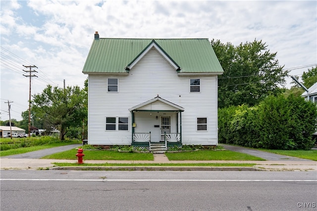 view of front of home with a porch and a front lawn