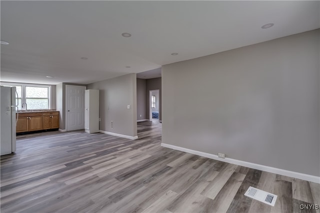 unfurnished living room with light hardwood / wood-style floors