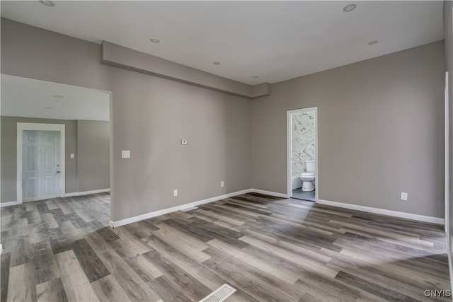 empty room with hardwood / wood-style floors