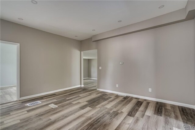 unfurnished room with wood-type flooring